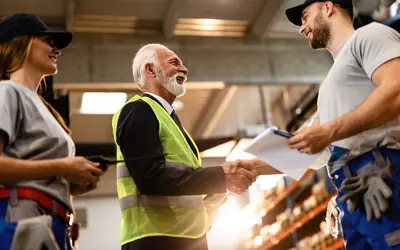 Manager greeting his team in a warehouse