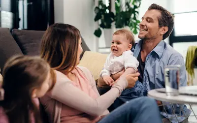 Family playing with their children in the living room