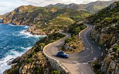 Car driving along a winding coastal road