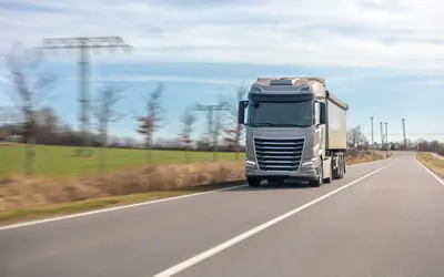 Cargo truck driving along a rural road
